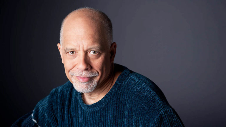 Portrait of Dan Hill against a grey background