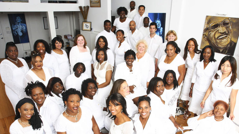 Portrait of Toronto Mass Choir wearing all white clothing