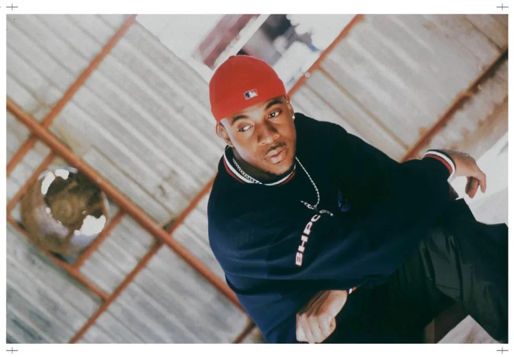 Maestro wearing a red baseball cap and blue long shirt for a photo shoot.