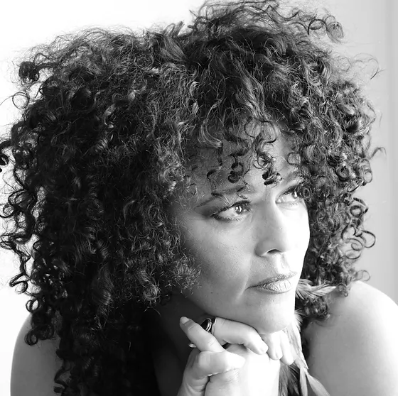 Black and white close-up of Dawn Tyler Watson glancing to her side.