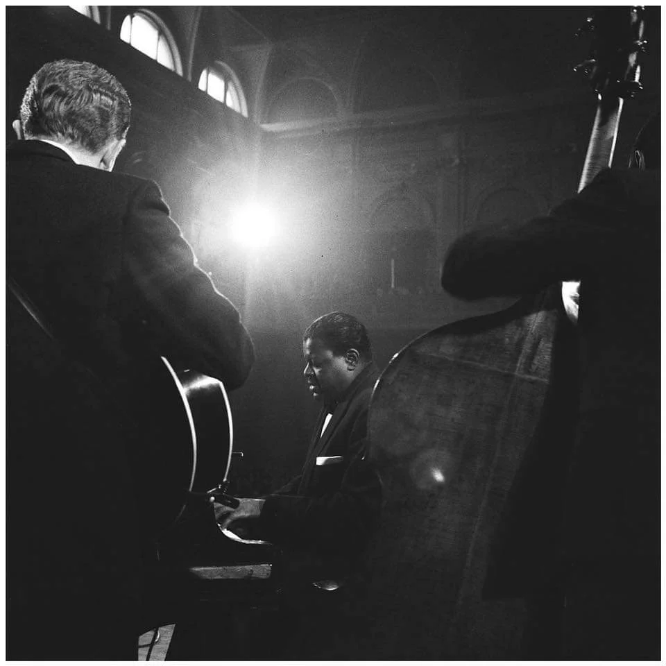 Oscar Peterson playing the piano and performing in a concert with Herb Ellis at Amsterdam