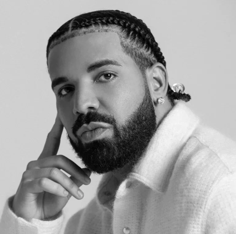 Drake touching his face for photo shoot.