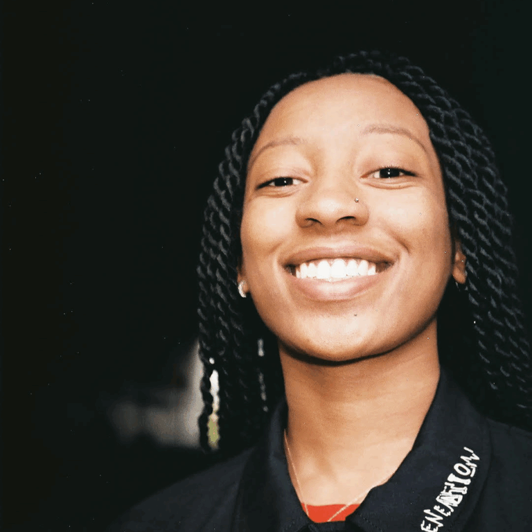 WondaGurl smiling at camera wearing black jacket