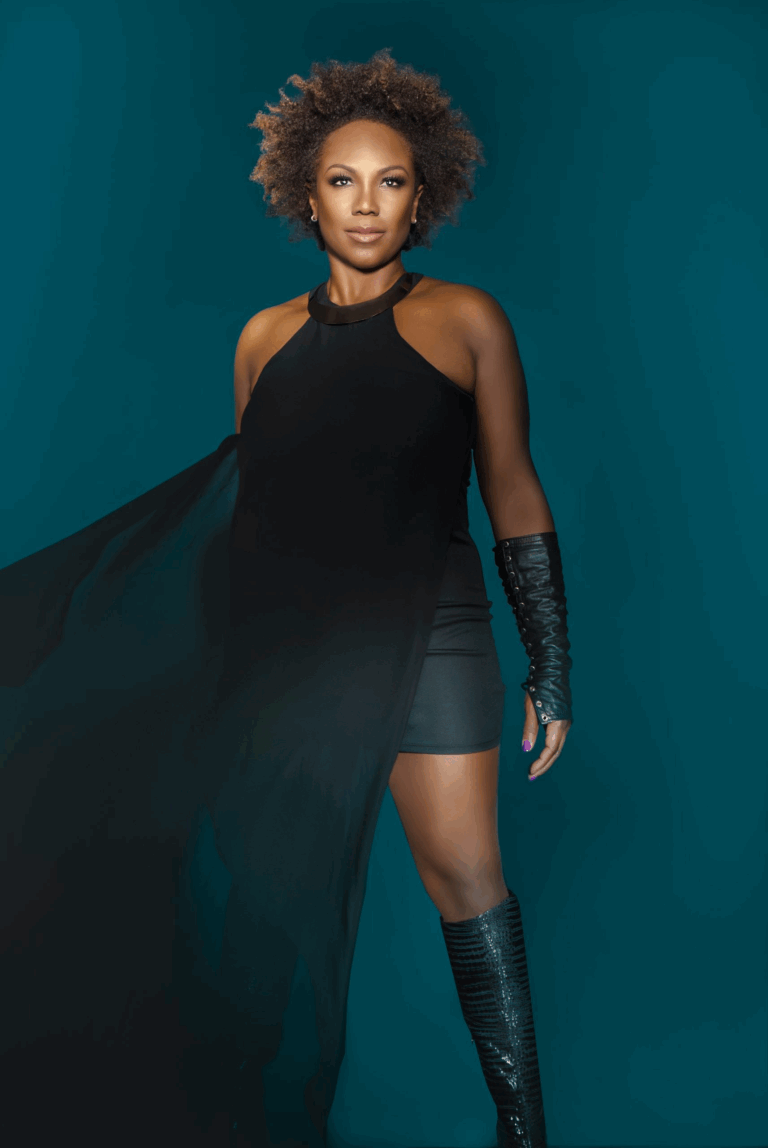 Dione Taylor dressed in black in front of blue background, - album cover