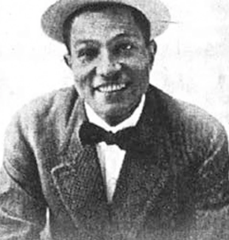 Close-up of Shelton Brooks in black and white smiling and wearing a bow-tie