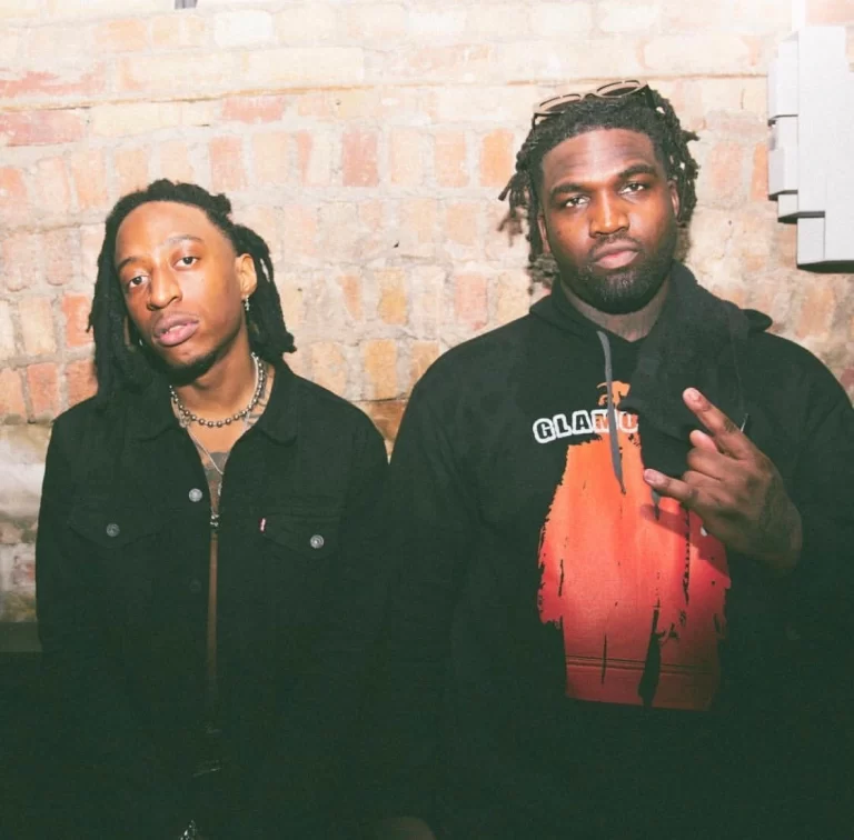 88Glam posing in front of brick wall