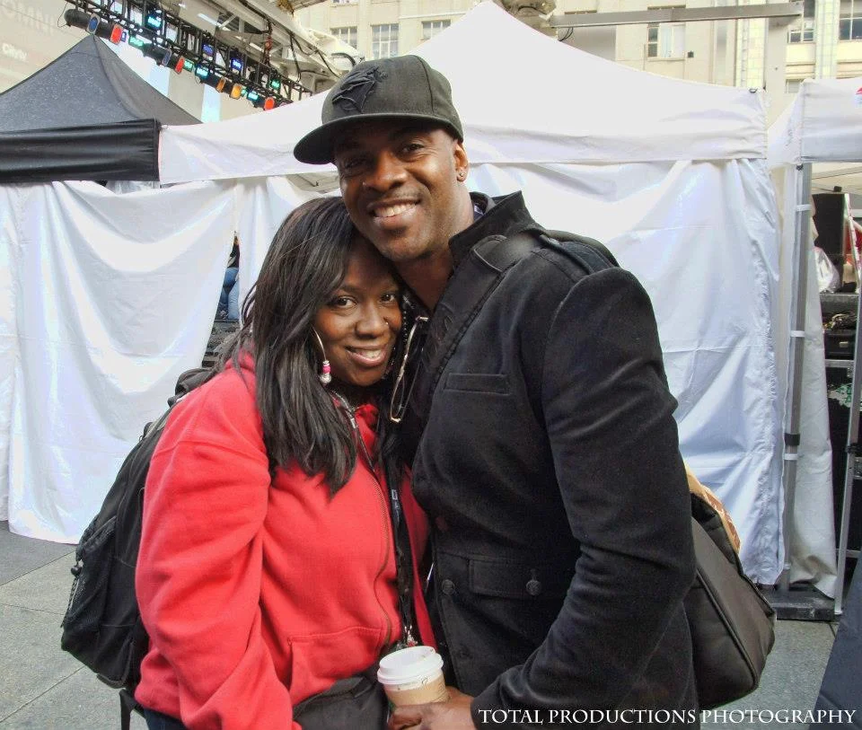 DJ Mel Boogie and Maestro [Maestro Fresh Wes] smiling together near a concert stage