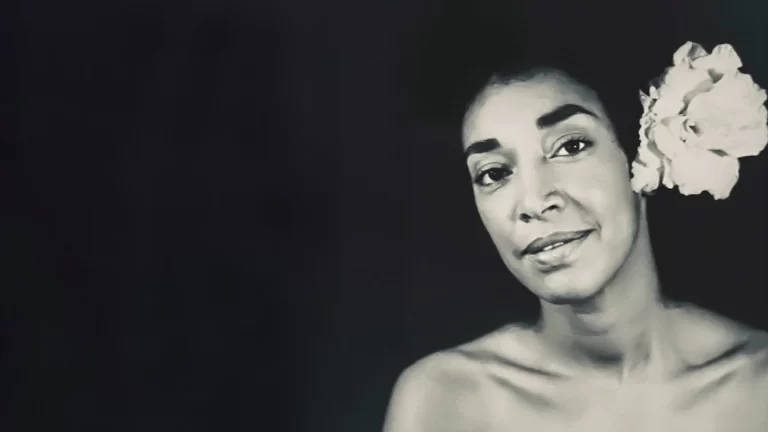 Black and white photo of Judi Singh with flower in her hair