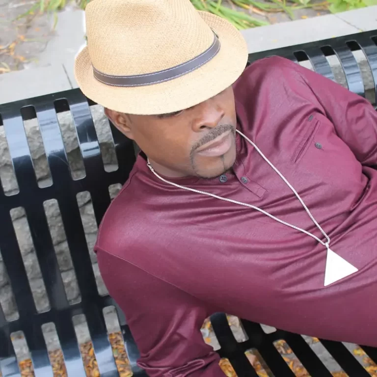Dave Vassell lying down on bench with hat over face