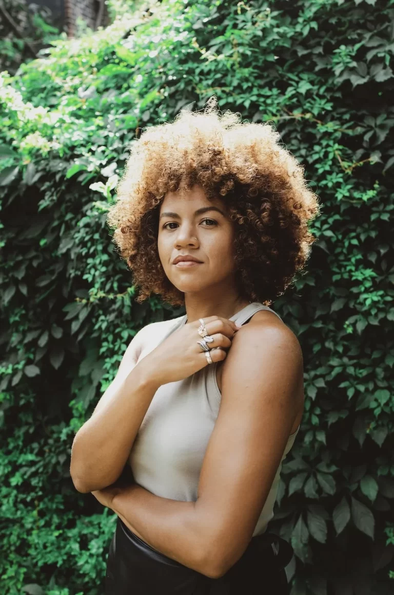Britta B posing in front of greenery