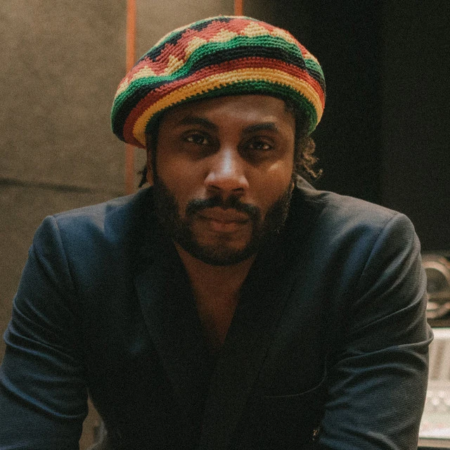 Jonathan Emile looking into camera wearing Jamaica coloured beanie