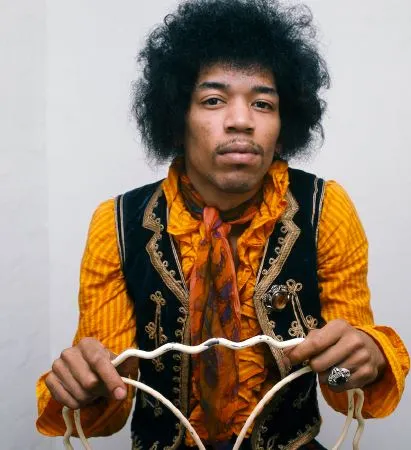 Hendrix sitting in a chair placed backwards