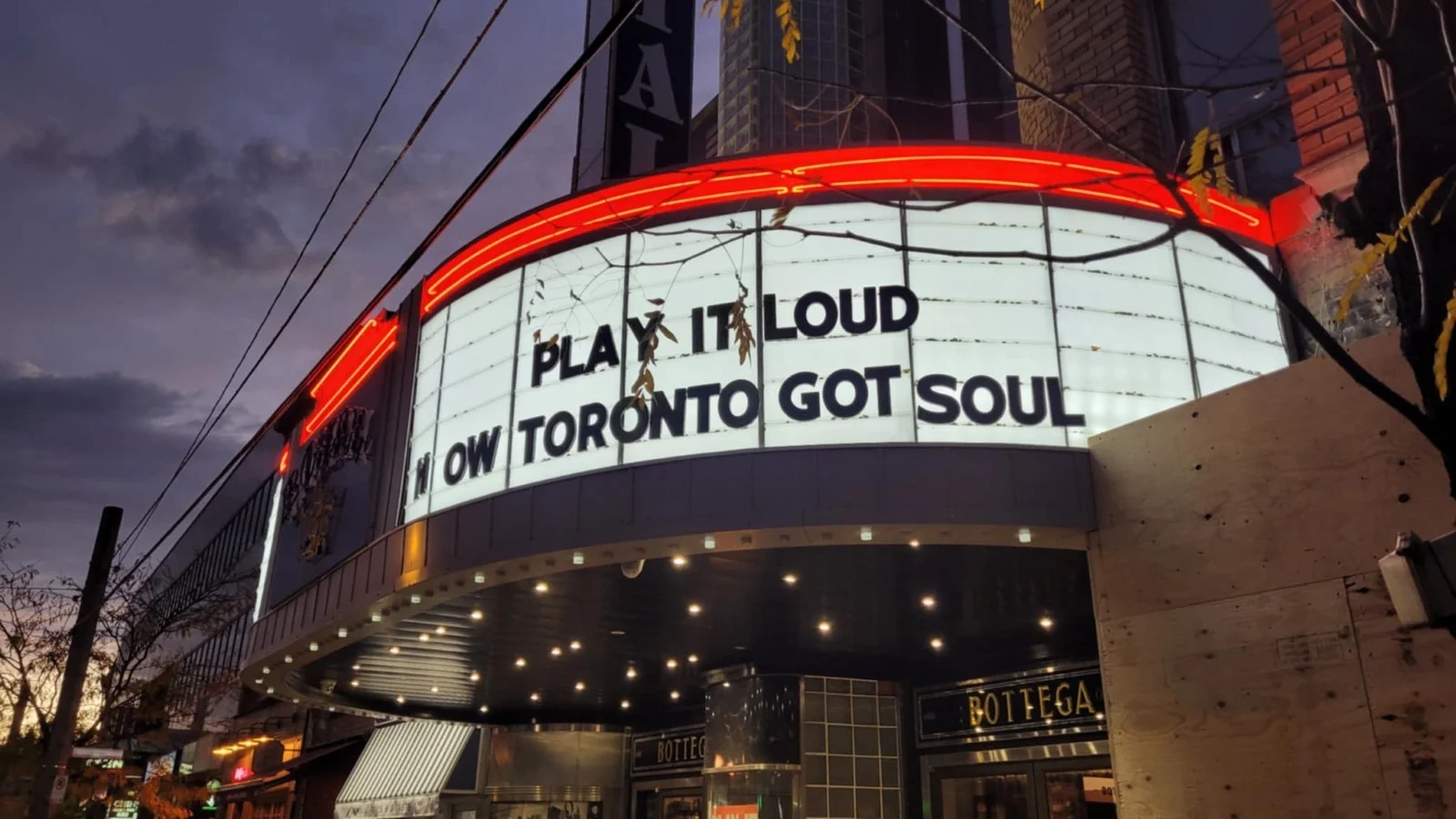 Exterior outside of a classic theatre, where the text "Play It Loud -- How Toronto Got Soul" is shown on the building's main display.